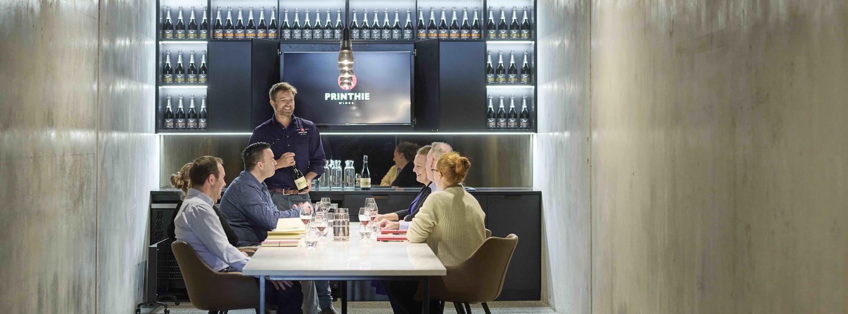 Image of group enjoying wine tasting in private conference room