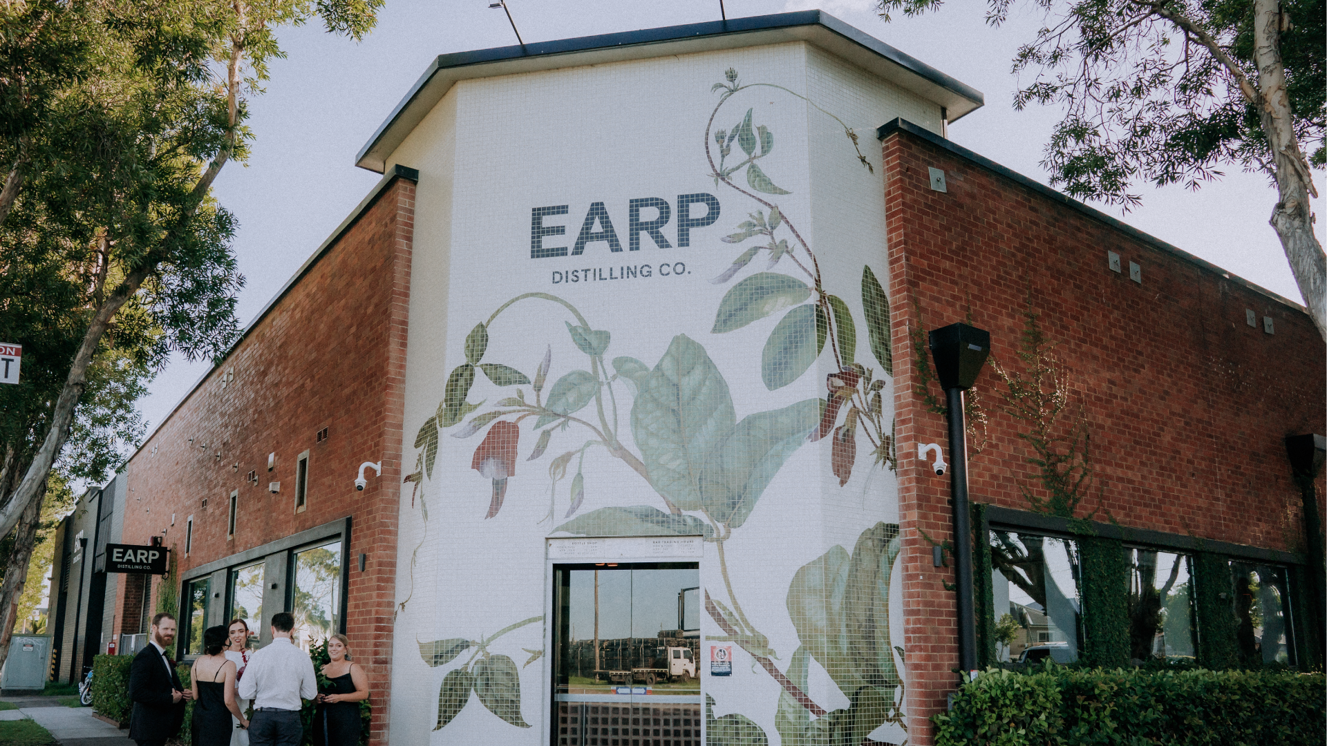 External shot of the venue's facade featuring a botanical illustration made of mosaic tiles