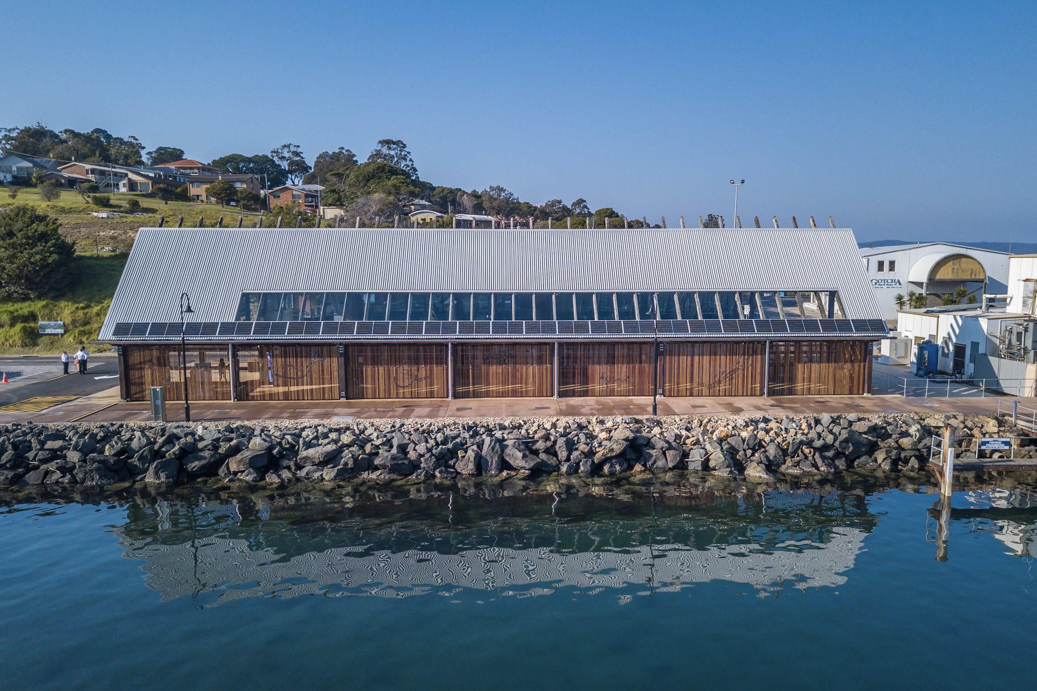 Image of the Eden Visitor Information Centre showcasing recycled timbers and harbourfront location